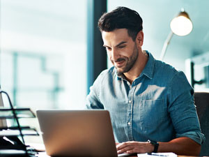 Engineer using Primatech’s process safety software on a laptop.